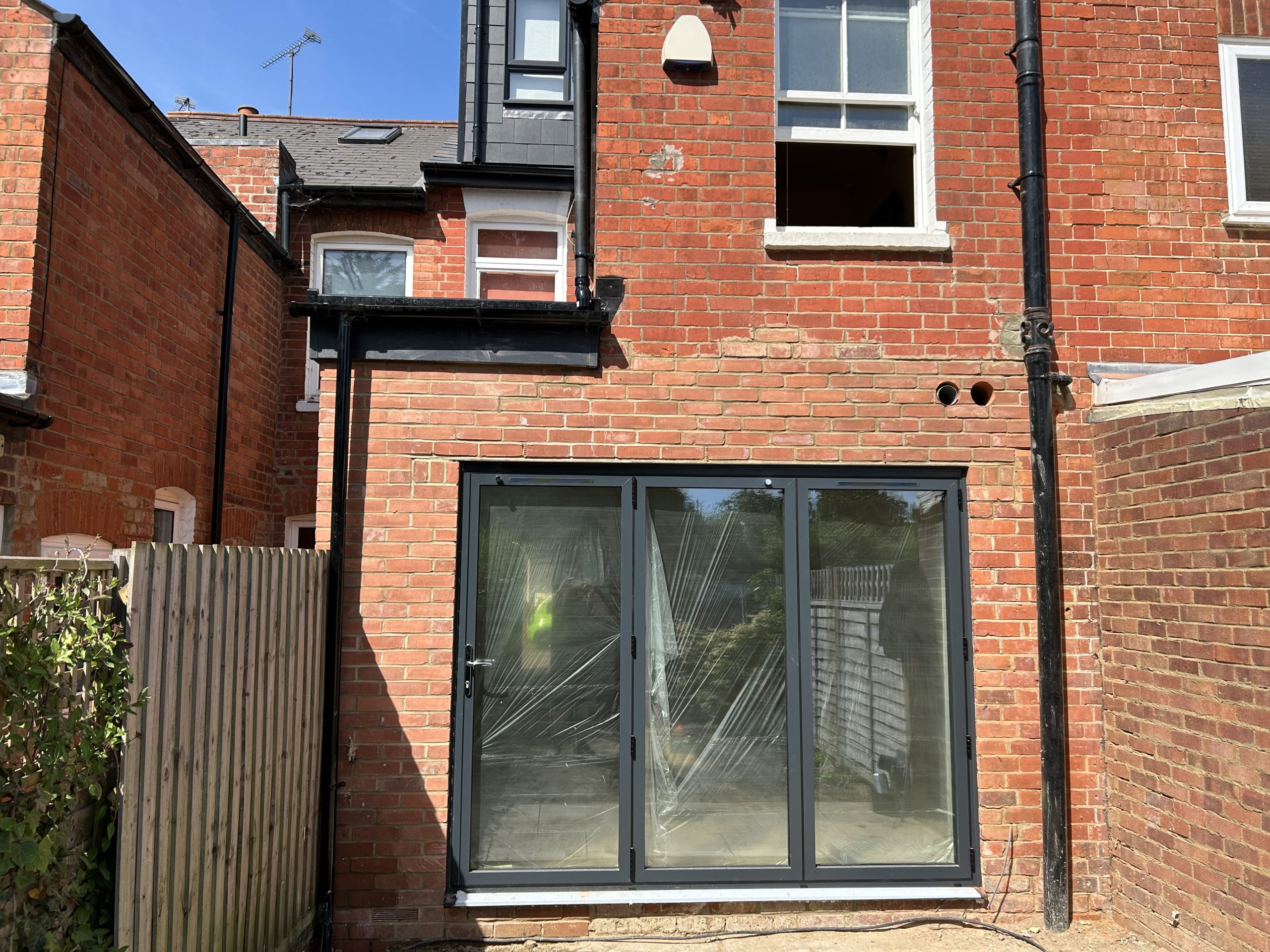 Victorian rear extension and loft conversion with anthracite grey aluminium bifold doors in Reading, Berkshire